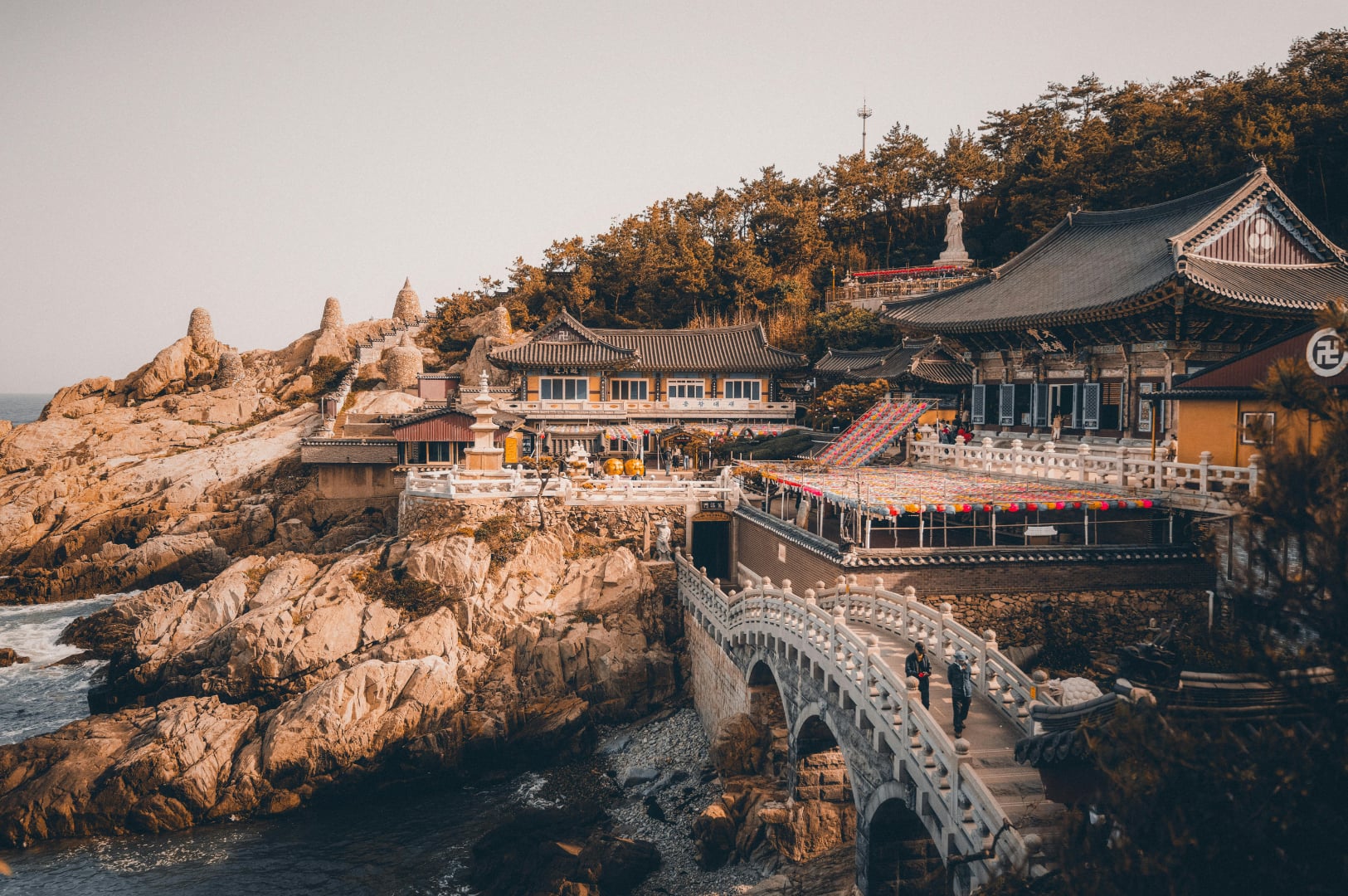 Haedong Yonggungsa Temple complex built into the rocky coastline overlooking the sea in Busan, South Korea.
