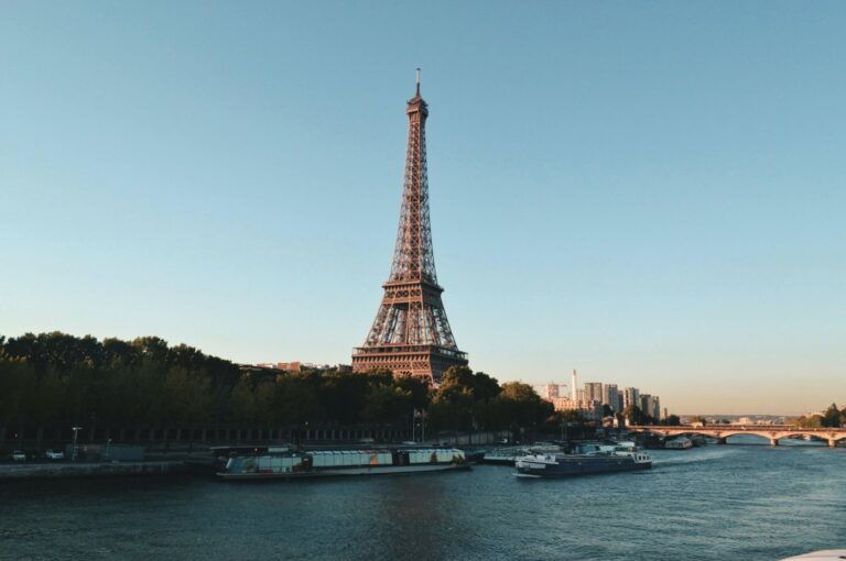 Panoramic view of the Eiffel Tower and Paris city architecture at sunset, ideal for European travel.