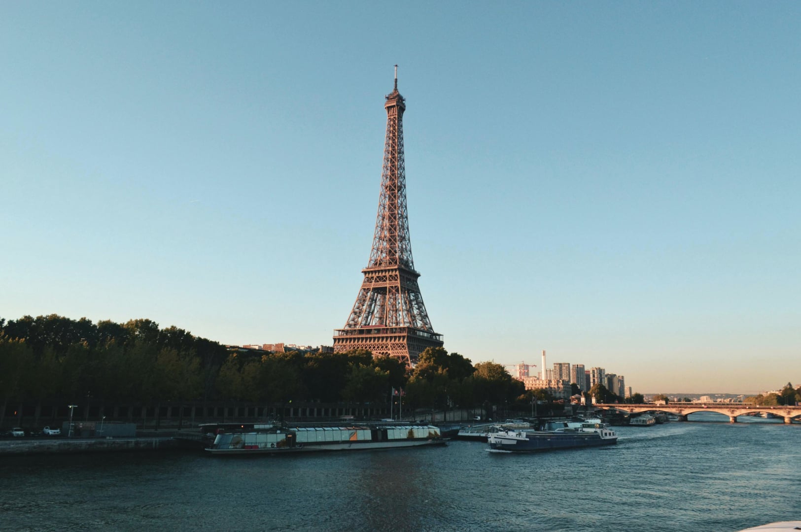 Panoramic view of the Eiffel Tower and Paris city architecture at sunset, ideal for European travel.