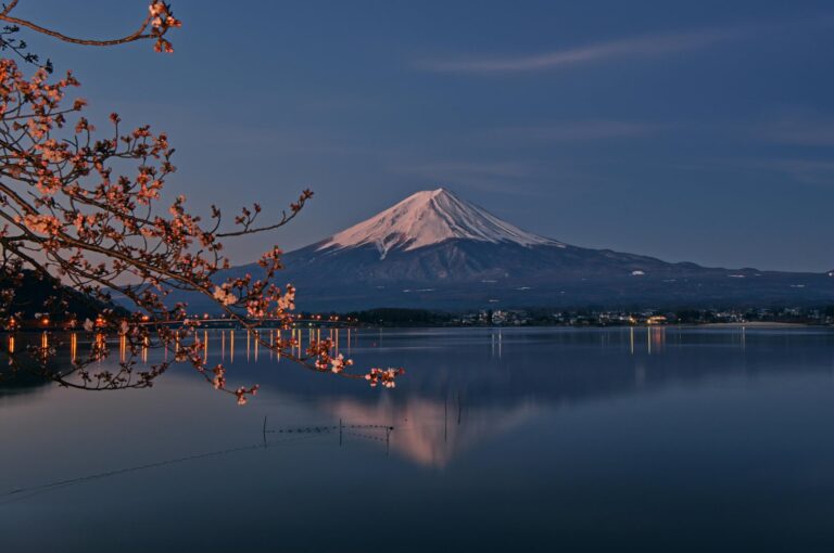 Majestic Mount Fuji rising above a traditional Japanese village, capturing the beauty of Japan travel.