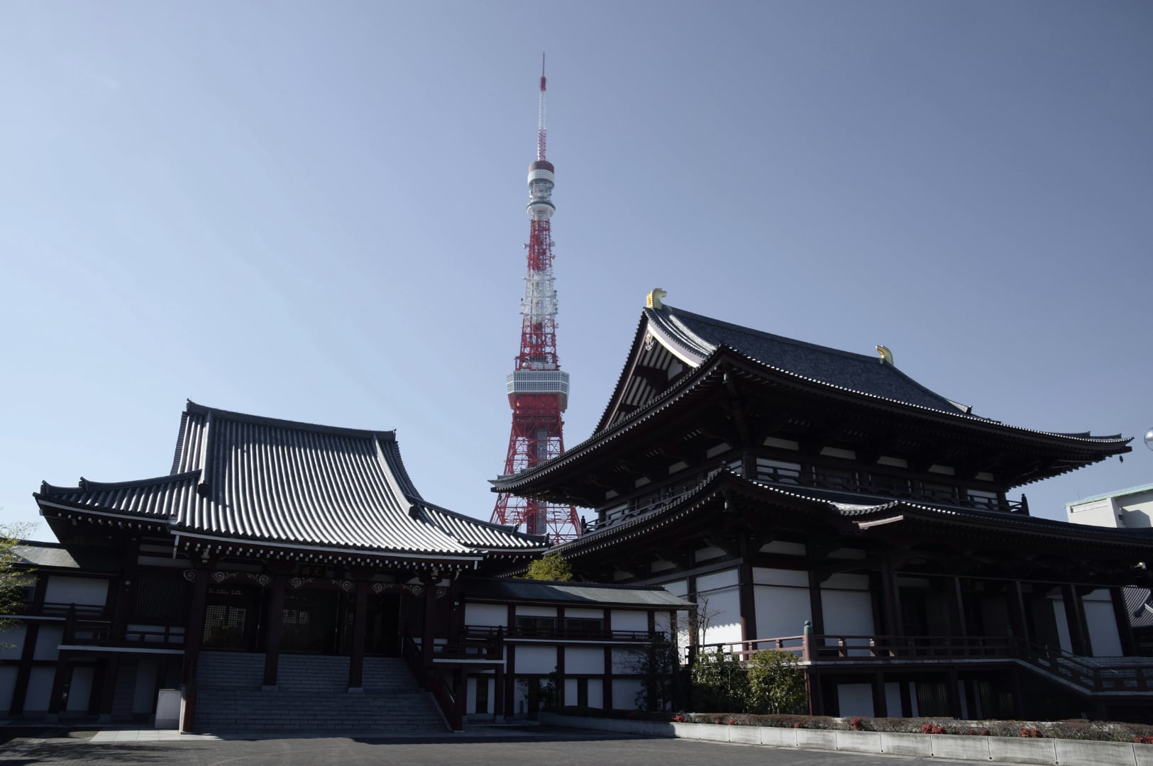 Zojoji Temple grounds with the modern red and white Tokyo Tower visible in the background, combining old and new Japan.