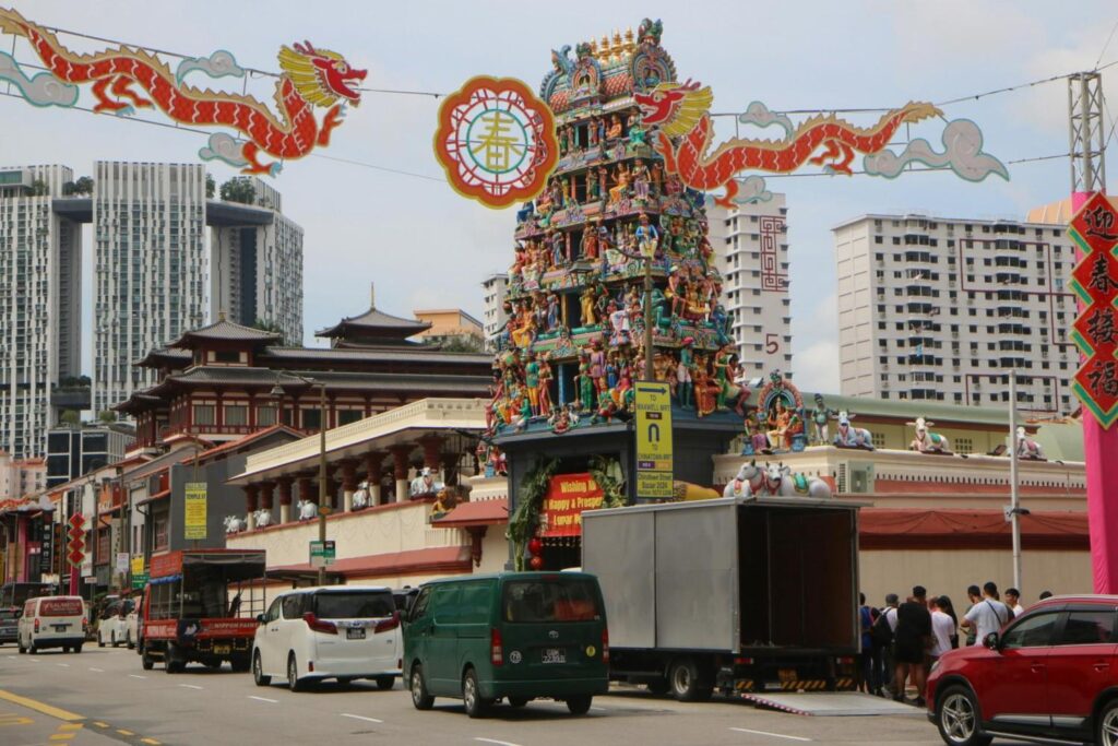 Sri Mariamman Hindu Temple in Chinatown Singapore with colorful street decorations.