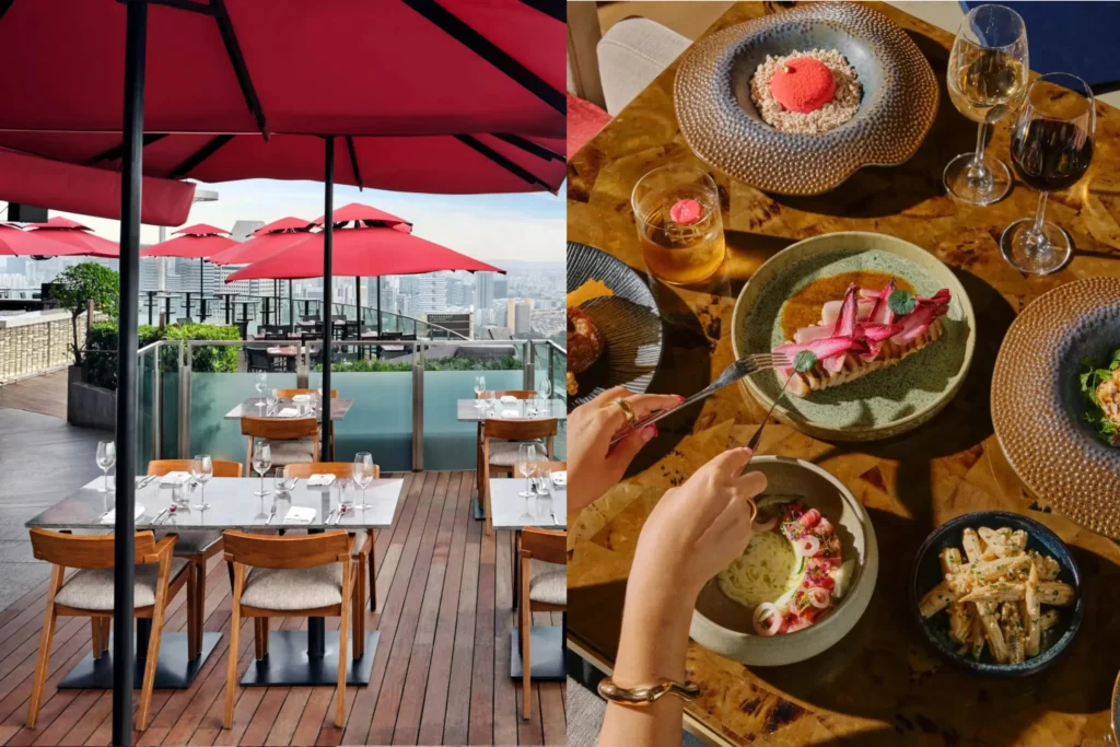 The image is a split composition showing an outdoor rooftop restaurant patio with wooden decking and large red umbrellas on the left, and a top-down view of a dining table laden with various gourmet dishes and drinks on the right. A person’s hands are visible using a fork and knife to slice into one of the beautifully plated dishes on the golden-toned table.