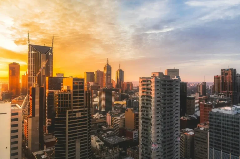 Golden sunset over the Melbourne city skyline, featuring high-rise skyscrapers and urban architecture in Victoria, Australia.